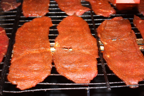We smoke/dry the beef jerky in a smokehouse.  Here is photo of the jerky laying on screens in the smokehouse.  Click on the photo to enlarge.